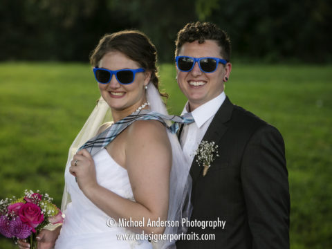 Bride & groom wearing blue sunglasses that everyone wore to their John P. Furber Farm wedding ceremony.