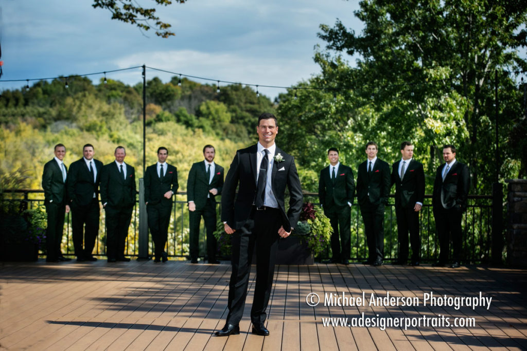 Wedding photo of the groom and his groomsmen and ushers taken on the deck before his Mississippi Gardens wedding in Minneapolis, MN.