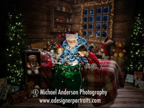 Santa Claus opens his "magic" toy bag to two cute cousins during the kids 2016 Heirloom Santa Claus Portraits.