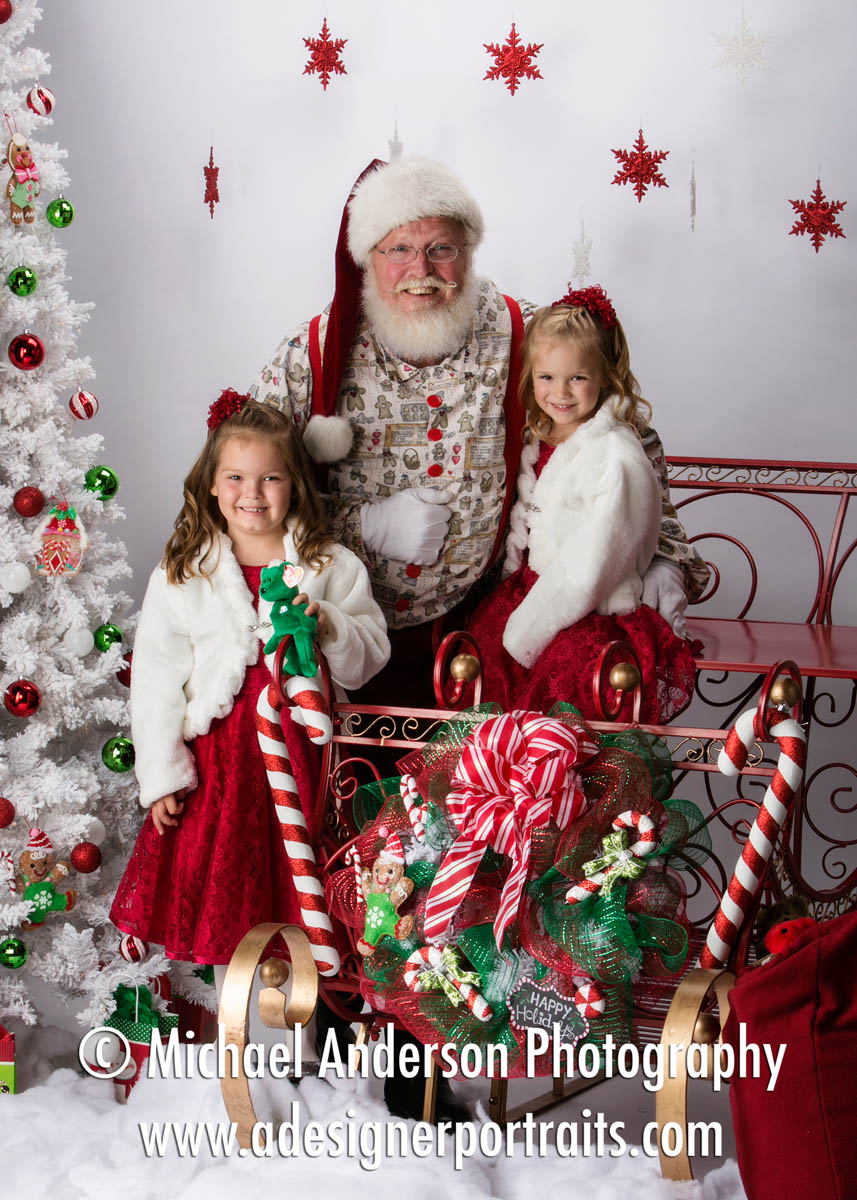 santa-claus-portraits-of-cute-five-year-old-twin-sisters-wearing-white-fur-coats-santas-sleigh  - Michael Anderson Photography