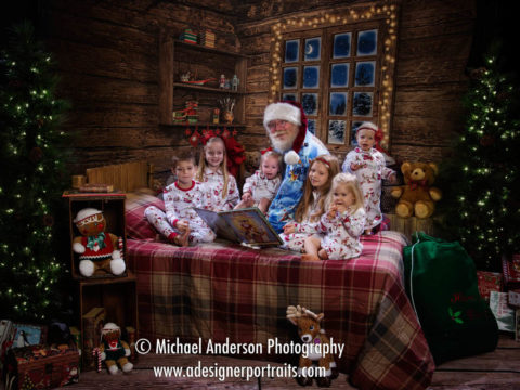 Six cute cousins pose with Santa Claus in their Christmas pajamas for their 2016 Heirloom Santa Claus Portraits for Cystic Fibrosis.