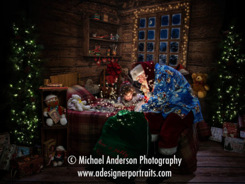 Santa Claus opens his "magic" toy bag to a five year old girl and her baby brother! 2016 Heirloom Santa Photos benefiting Cystic Fibrosis.