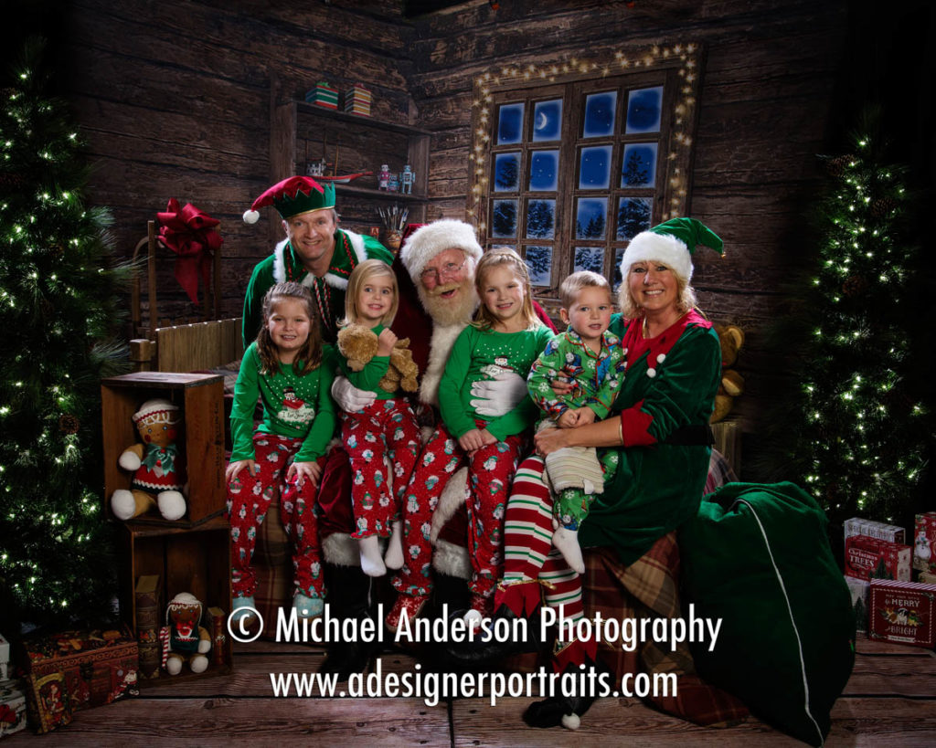 Two of Santa's Elves pose with four cute cousins and their Santa Claus portraits.
