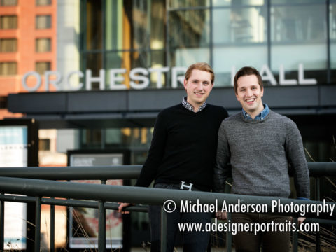 Two men pose for one of their Orchestra Hall engagement portraits with the famous building in the background.