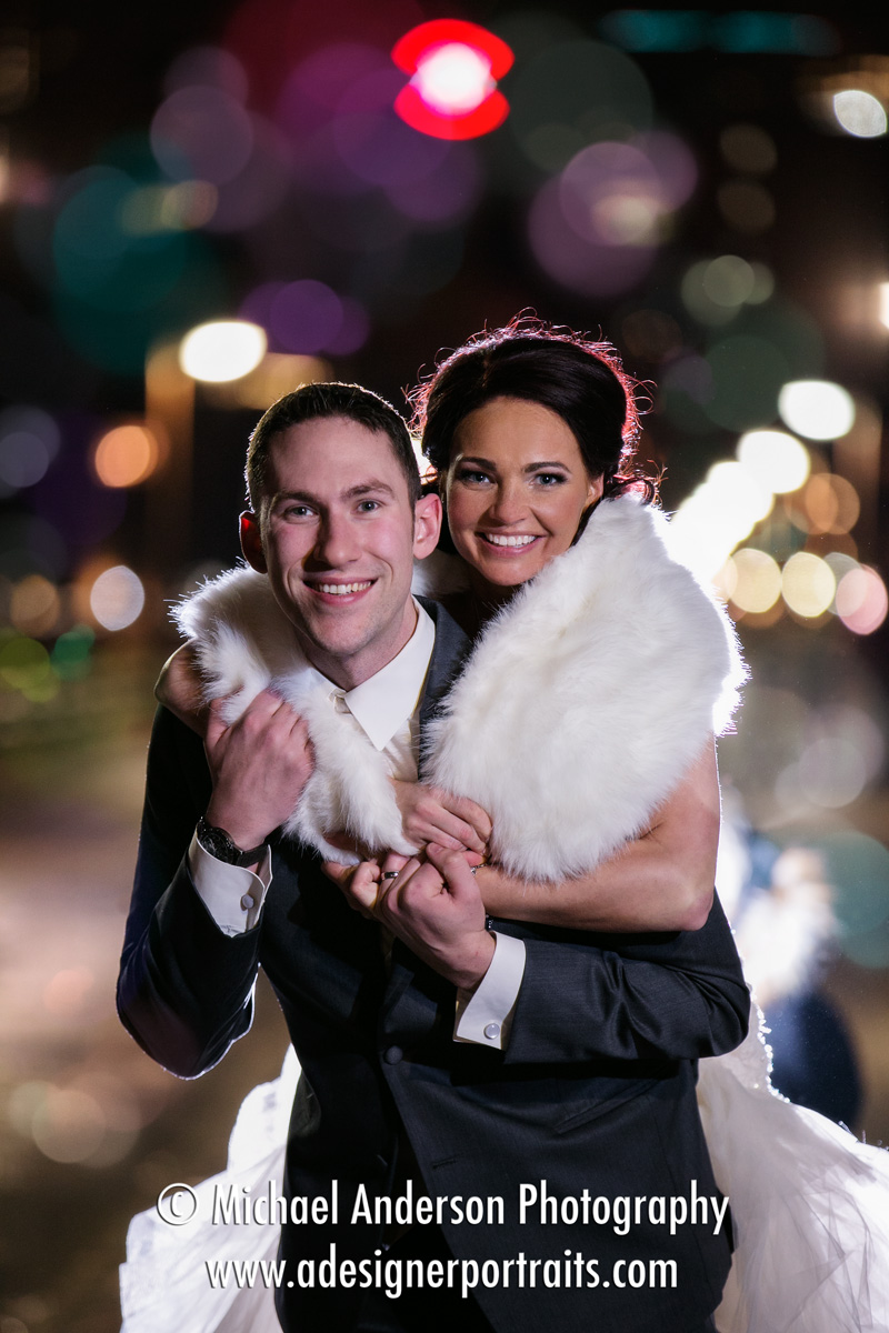 A fun and really pretty wedding photograph of a bride and groom on the historic Stone Arch Bridge in Minneapolis, MN.