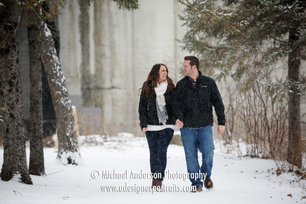 Very snowy engagement portraits taken in a snow storm at St. Anthony Main in downtown Minneapolis, MN.