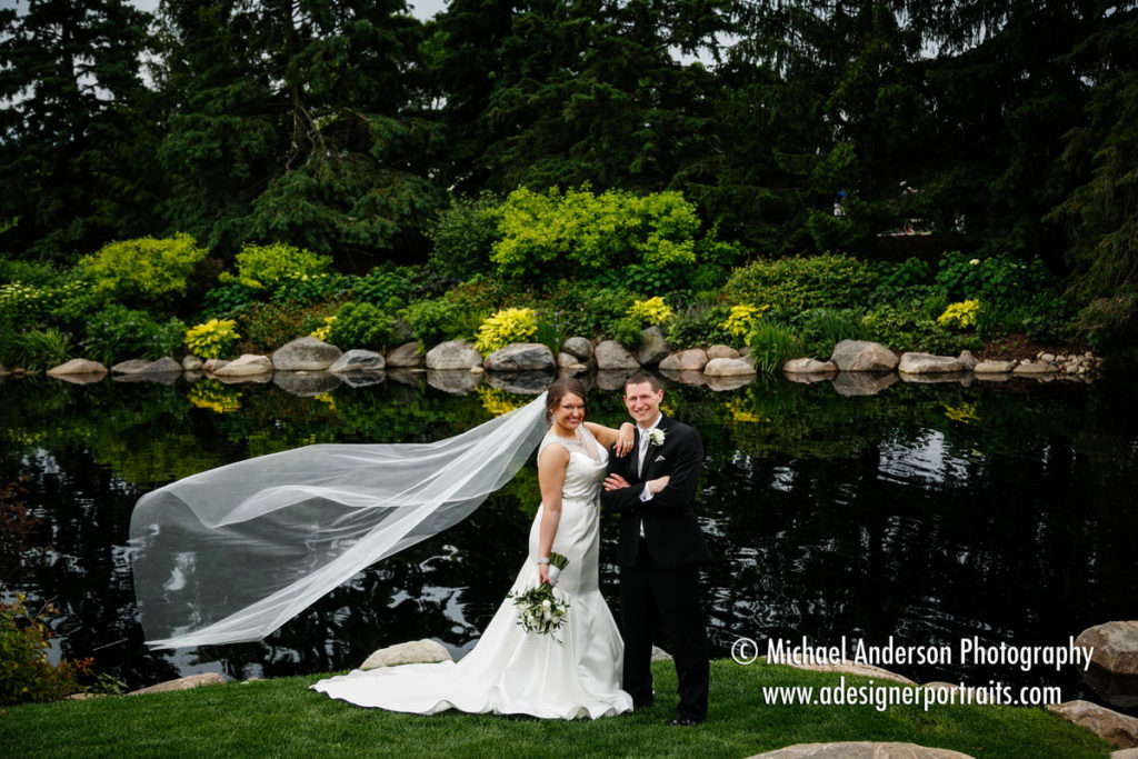 Bride and groom portrait taken by a pretty pond at their Olympic Hills Golf Club wedding.