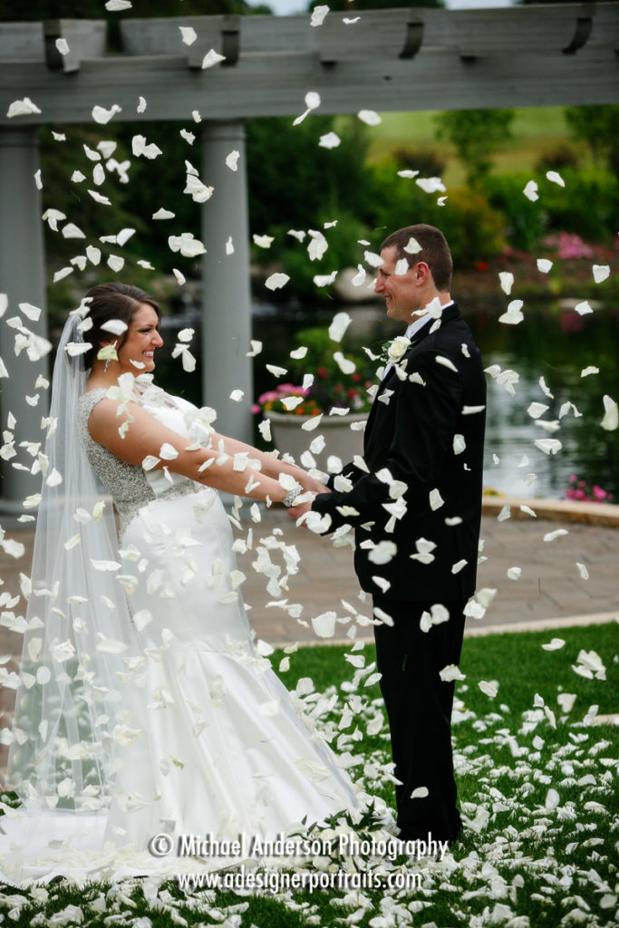 Bride & groom in a shower of rose petals. Image created at their Olympic Hills Golf Club wedding.