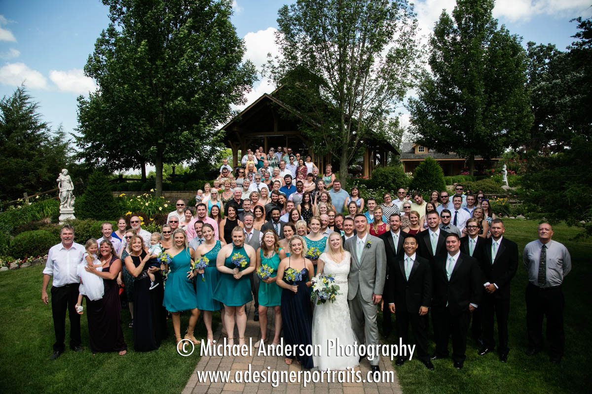 A fun group photo of all of the guests in attendance at Ricky & Rebecca's beautiful Panola Valley Gardens wedding in Lindstrom, MN.