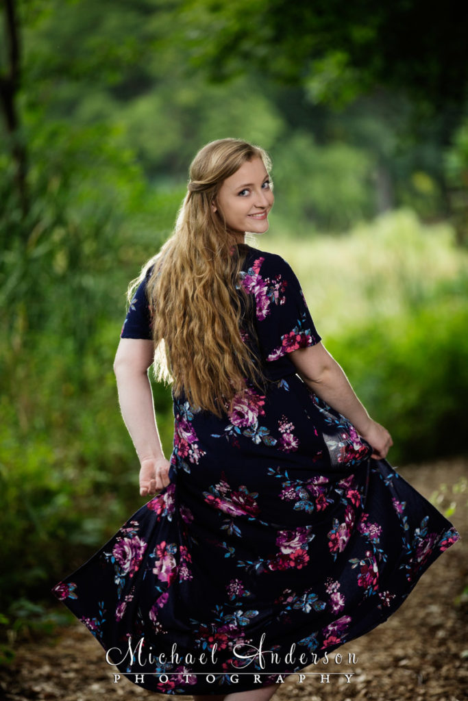 Pretty girl twirling in her dress during her Minnesota Landscape Arboretum senior portraits.