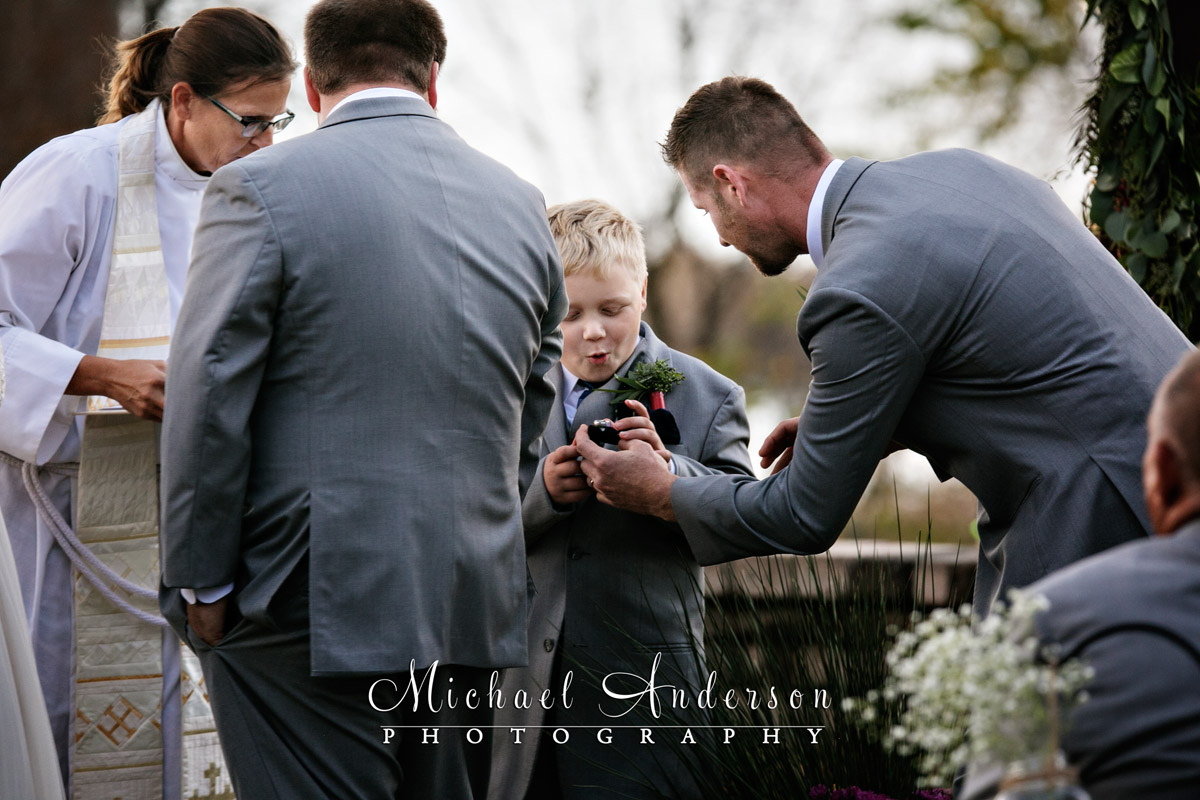 The priceless expression on the ring bearers face when he was handed the wedding rings during the Minnesota Horse and Hunt Club wedding.
