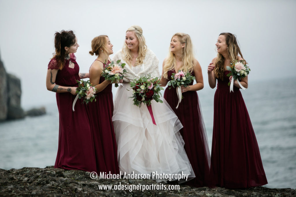 The bride and her bridesmaids standing on a rocky ledge at Split Rock Lighthouse State Park in MN. Image was taken from long range with a Tamron SP 150-600MM F/5-6.3 Di VC USD super telephoto lens.
