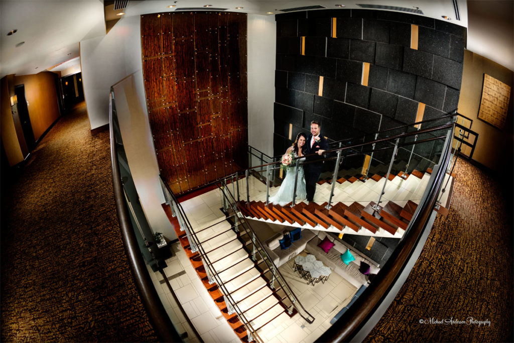 Hilton Light Painting Wedding Photograph. The finished light painting of the bride and groom on the pretty staircase in the hotel lobby. Image was created during their wedding dance held at the Hilton Minneapolis Bloomington.