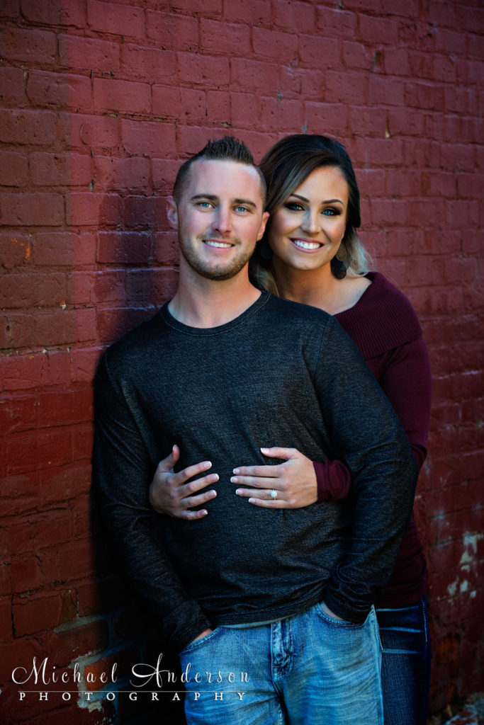 Fall Stillwater Engagement Portraits. One of Corey and Ashley's fall Stillwater engagement portraits by a red brick wall in downtown Stillwater, MN.