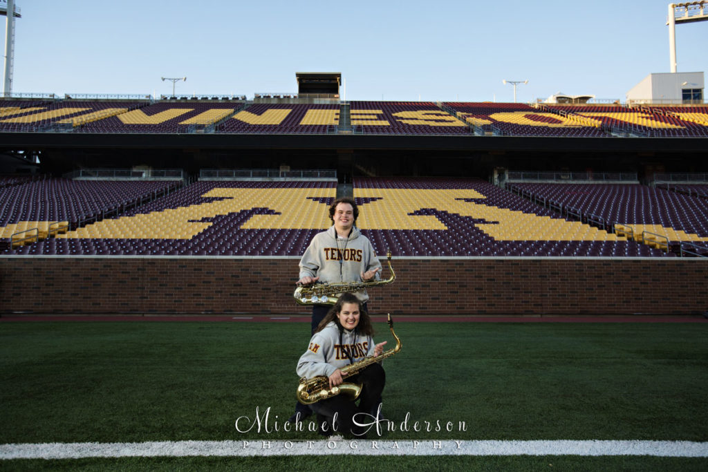 Engagement Portraits at TCF Bank Stadium. Two former U of M Marching Band members on the field for one of their engagement portraits.