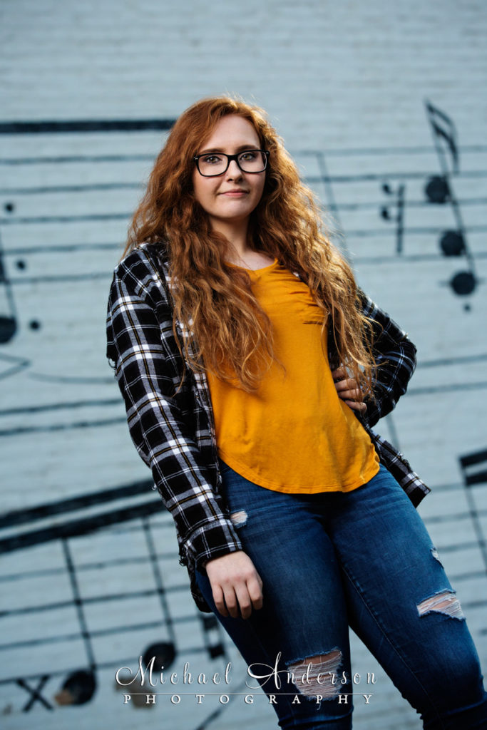 Morgan, a high school senior, strikes a pose in front of the huge music street mural in downtown Minneapolis, MN. This is just one of many of her senior portraits created all over Minneapolis, MN.