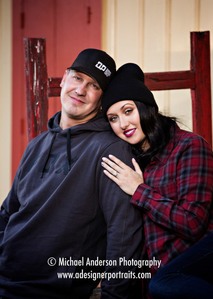 A very cute couple cuddling at the train station during their Long Lake Regional Park engagement portraits.