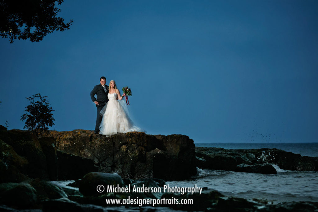 A pretty destination wedding photograph taken on a rocky ledge at Grand Superior Lodge on Lake Superior.