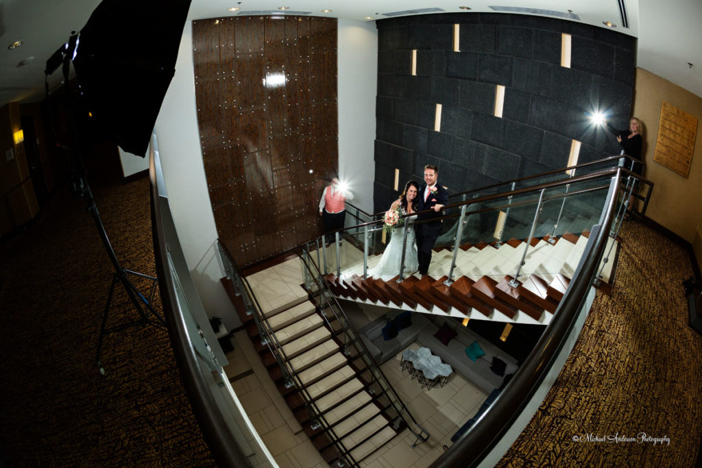 The bride and groom on the pretty stairway before their Hilton Light Painting Wedding Photograph started. Image was created during their wedding reception at the Hilton Minneapolis Bloomington.