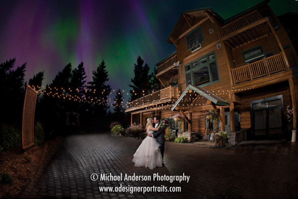 A stunning light painting wedding photograph of a bride & groom created at their Grand Superior Lodge destination wedding on Lake Superior. The final fantasy light painting has the couple under under the aurora borealis.