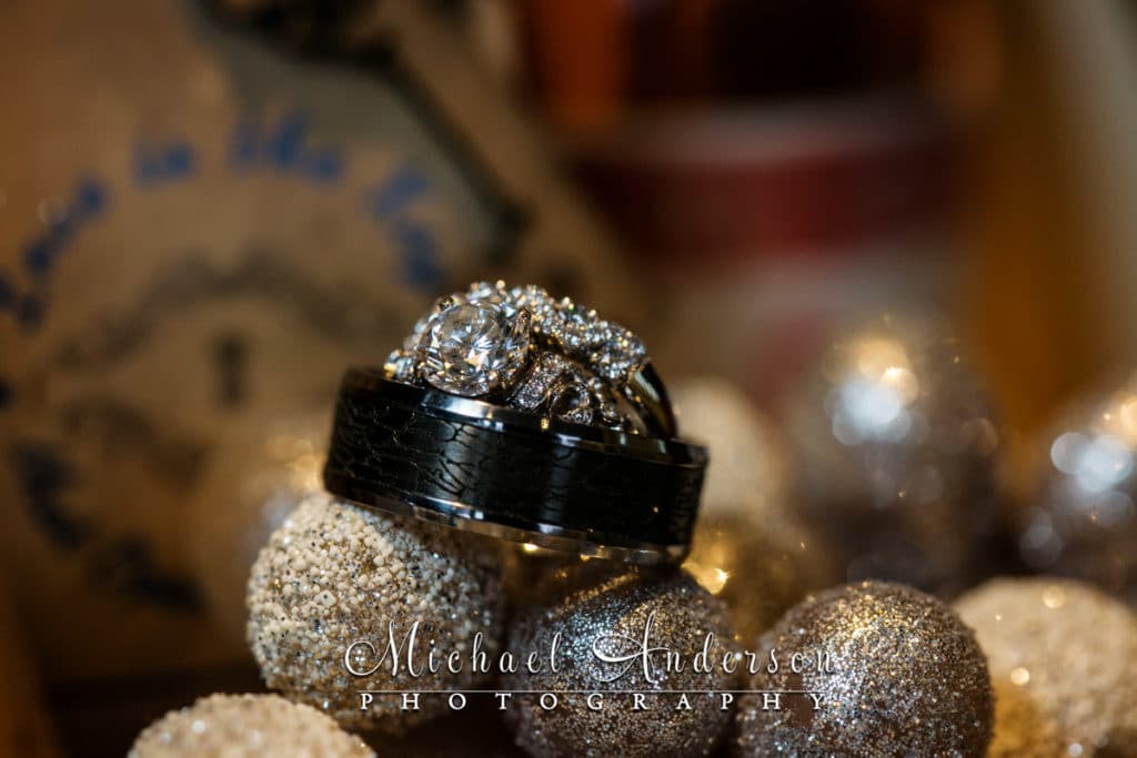 A macro photo of wedding rings in a pretty table decorations at their Windows On Minnesota wedding reception.