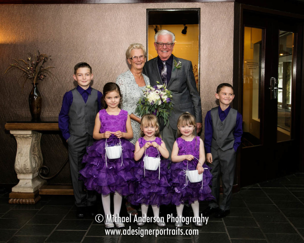 The bride and groom along with their adorable junior wedding party. Wedding photograph was taken at their Crowne Plaza Plymouth wedding.