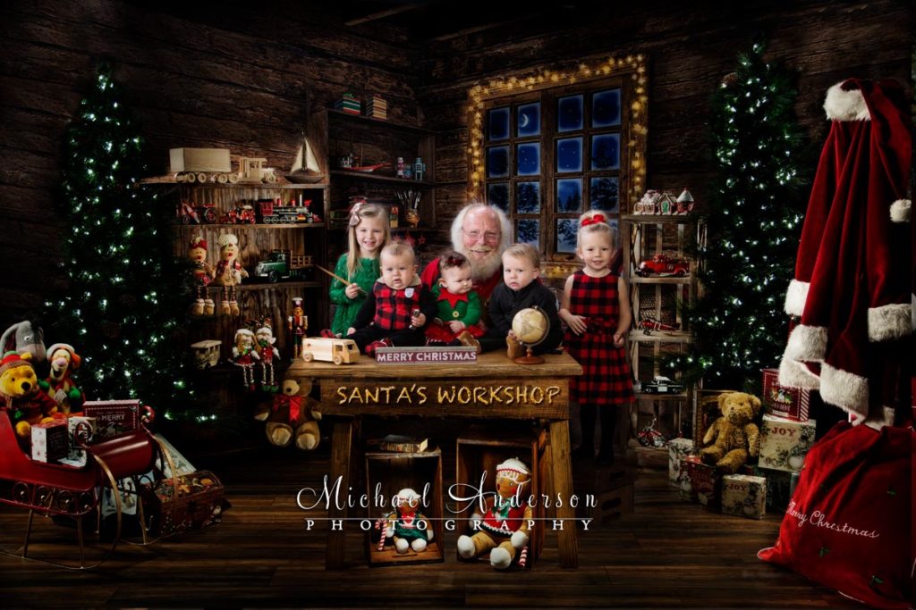 Five little friends pose with Santa Claus in Santa's Workshop.
