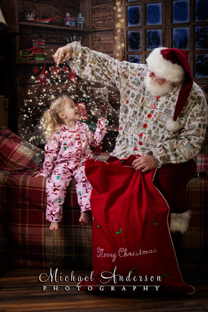 Santa shares a little "magic" with an adorable three year old. All part of The Santa Experience and Storytime with Santa for Cystic Fibrosis.
