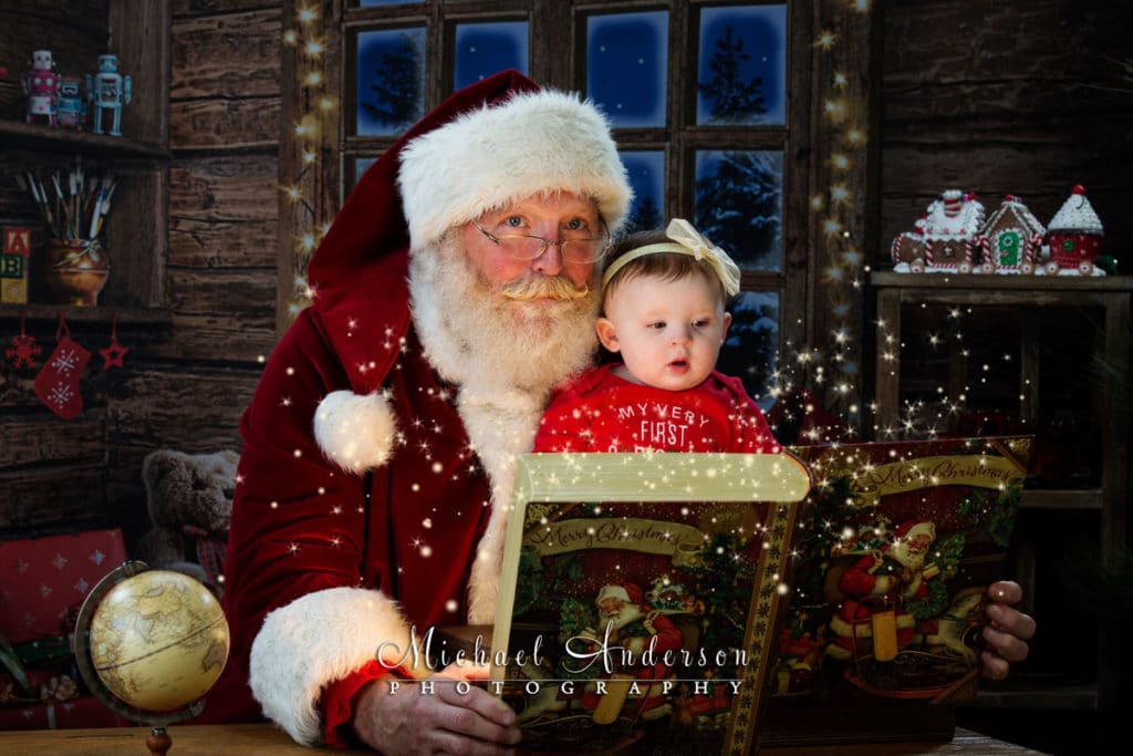 Adorable little Mackenna listens to a story from Santa Claus in Santa's Workshop.