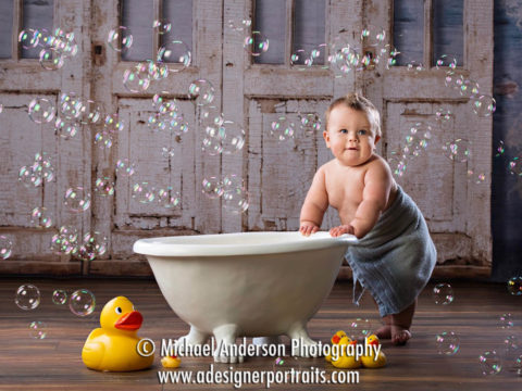 Mounds View Photographer. Bath Time baby photos of an adorable nine-month-old standing in a towel.