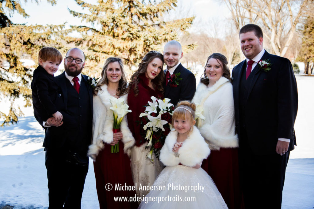Winter wedding photo of a wedding party outside at New Hope Village Golf Course in New Hope, MN.