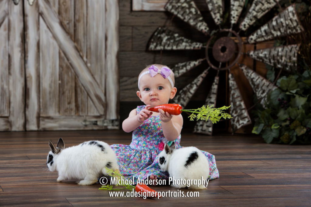 Mounds View MN Portrait Photographer Easter Photos With Real Bunnies. An adorable little girl holding a carrot for her 2018 Easter Photos With Real Bunnies