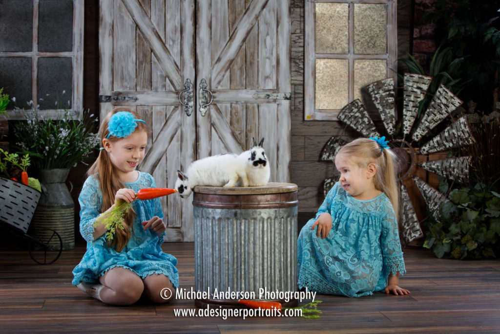 Mounds View MN Portrait Photographer Easter Bunny Photographs. A fun Easter portrait of two sisters having fun with two cute bunnies.