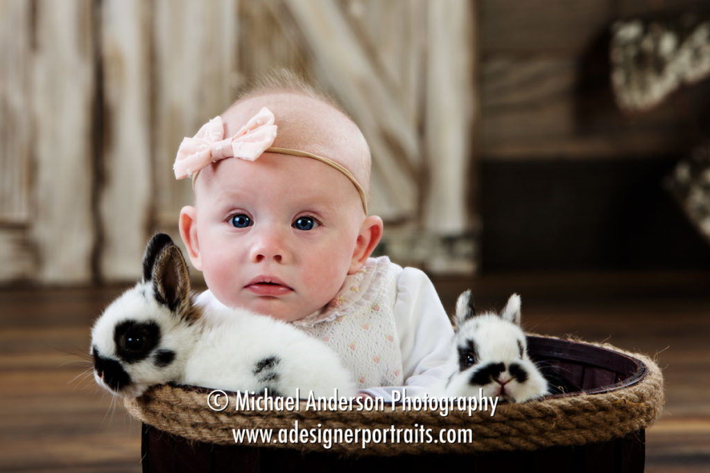 Mounds View MN Photographer Easter Bunny Photos 2018. Sweet little Brielle has a close up encounter with our real bunnies for her Easter portraits for 2018.