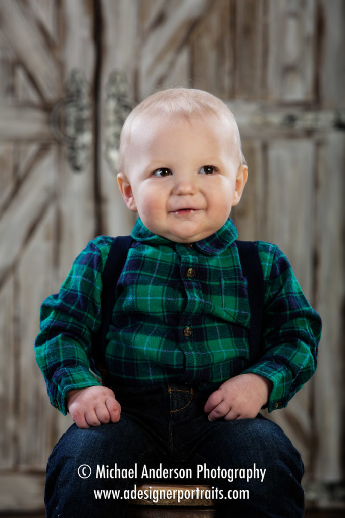 Cute little Noah's one-year-old portraits in a cute barn setting.