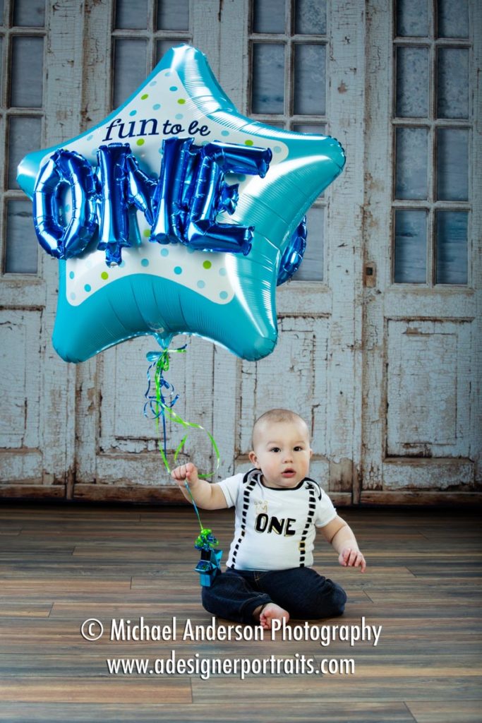 Marcus' one-year-old photos with a giant birthday ballon.