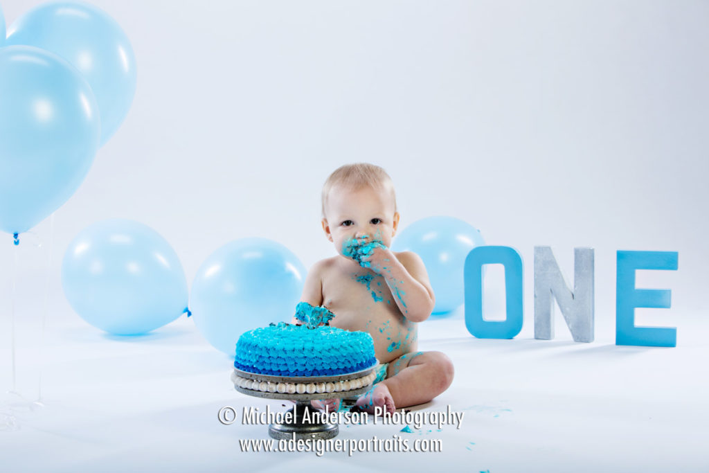 Cute little Noah's one-year-old portraits. He's having his birthday cake and balloons.