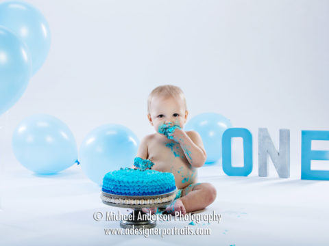 Cute little Noah's one-year-old portraits. He's having his birthday cake and balloons.
