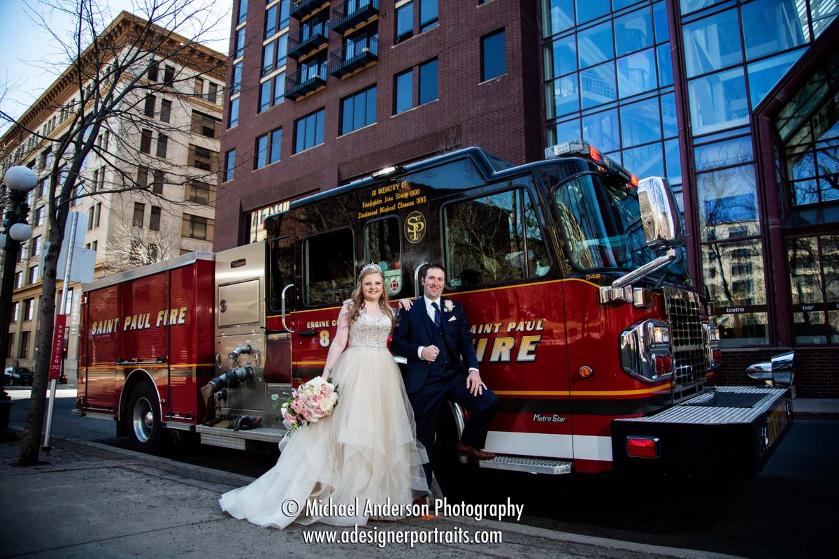 ABULAE wedding photos of a bird and groom with a fire truck in downtown Saint Paul, MN.