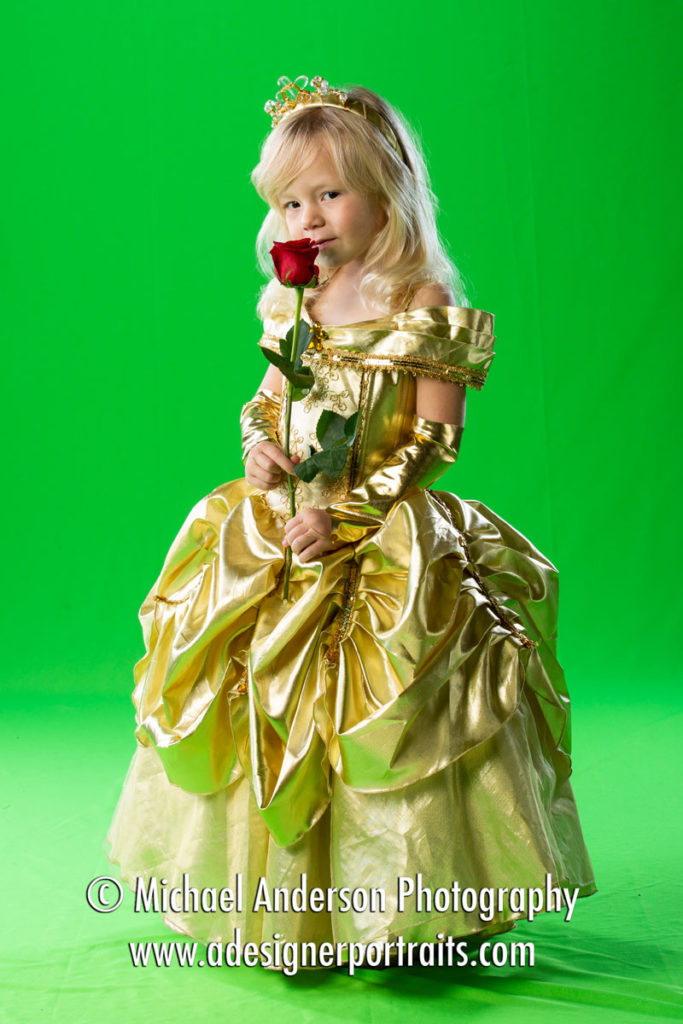 Green screen portrait of a pretty four-year-old girl dressed as Belle. The photo was taken for a Beauty and the Beast Photo Composite.
