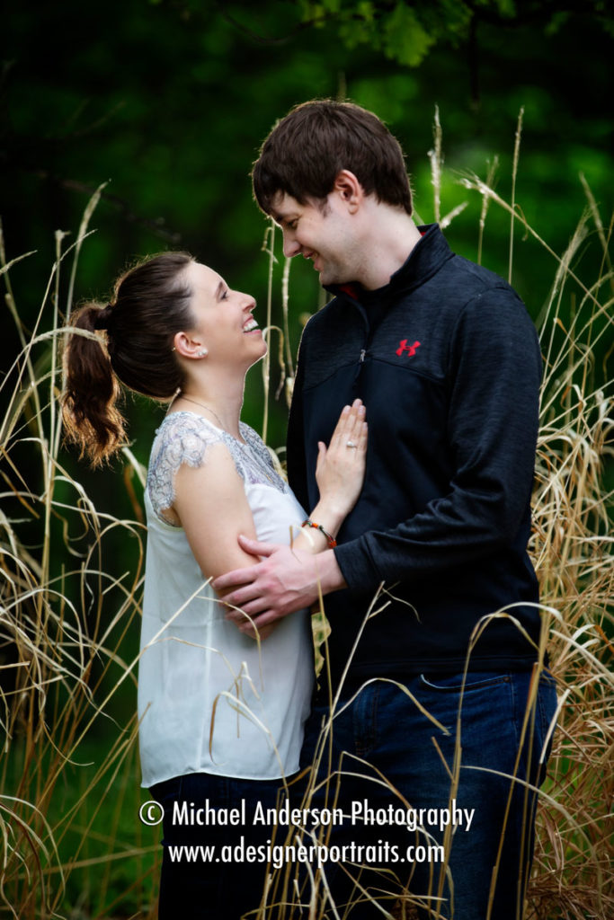 Silverwood Park engagement portraits in Saint Anthony, MN. A cute couple standing in the tall grasses at the pretty park.