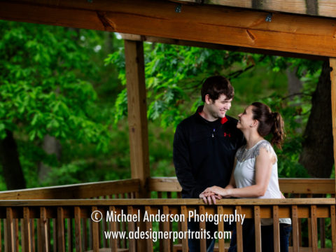 Silverwood Park engagement portraits in Saint Anthony, MN. A cute couple standing in a pretty wooden structure at Silverwood Park.