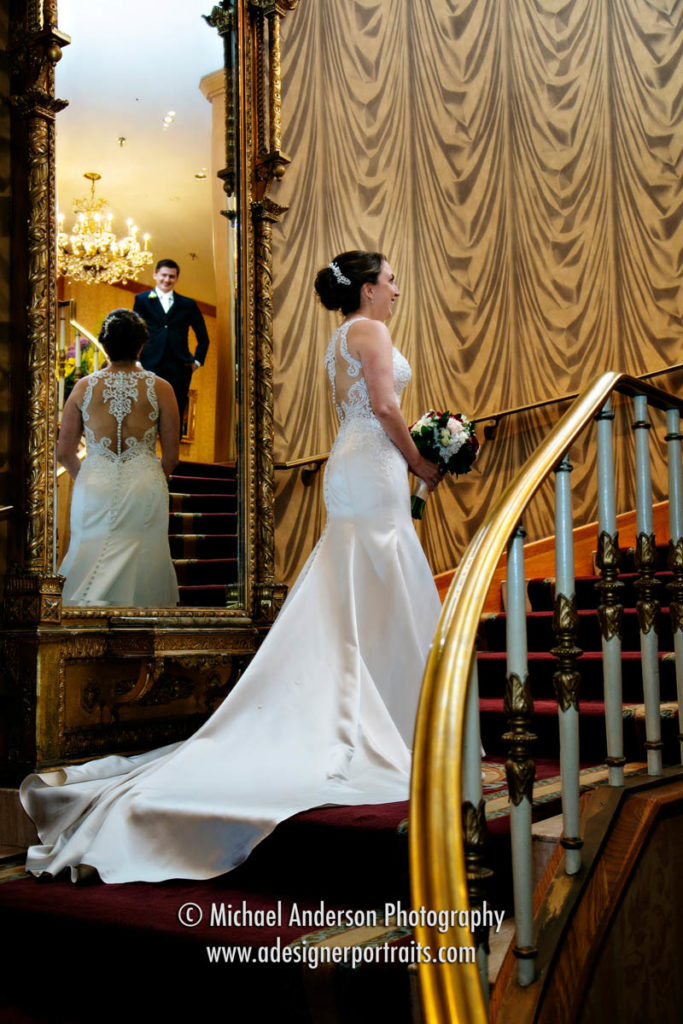 Bride and groom sharing having their first look on the Grand Staircase at The Saint Paul Hotel in downtown St. Paul, MN.