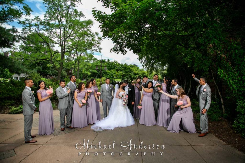 A bride and groom and their large wedding party at Centennial Lakes in Edina, MN.