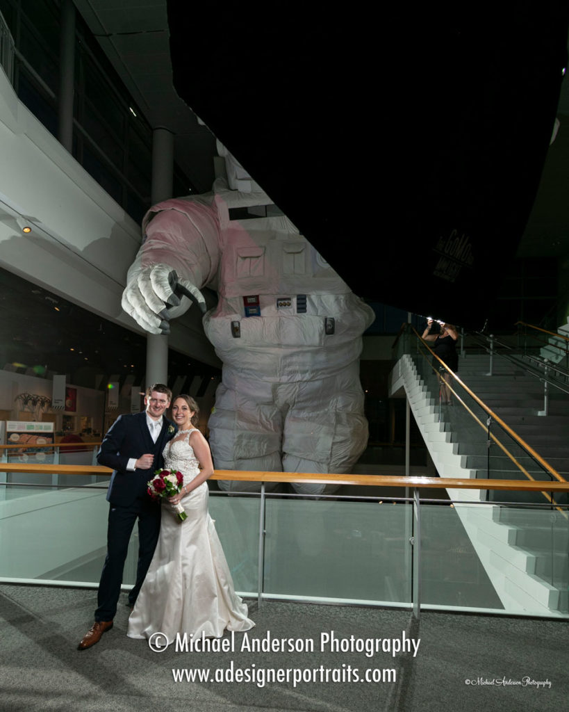 Science Museum of Minnesota light painting. The starting image, before light painting, of the bride & groom, in front of the huge astronaut on display.