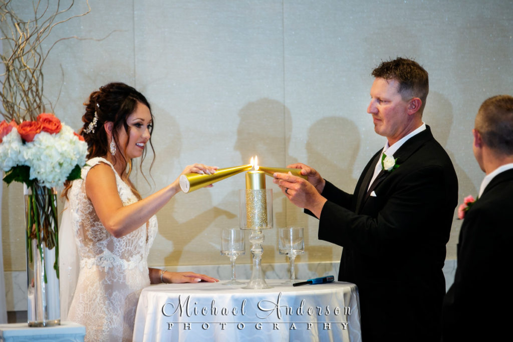 Mystic Lake Casino wedding pictures of the bride and groom lighting their Unity Candle at the Mystic Lake Center.