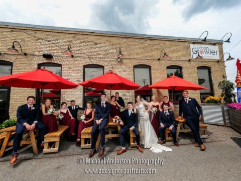 Ultra-wide angle Urban Growler Brewing Company wedding photo of a wedding party just outside the building.