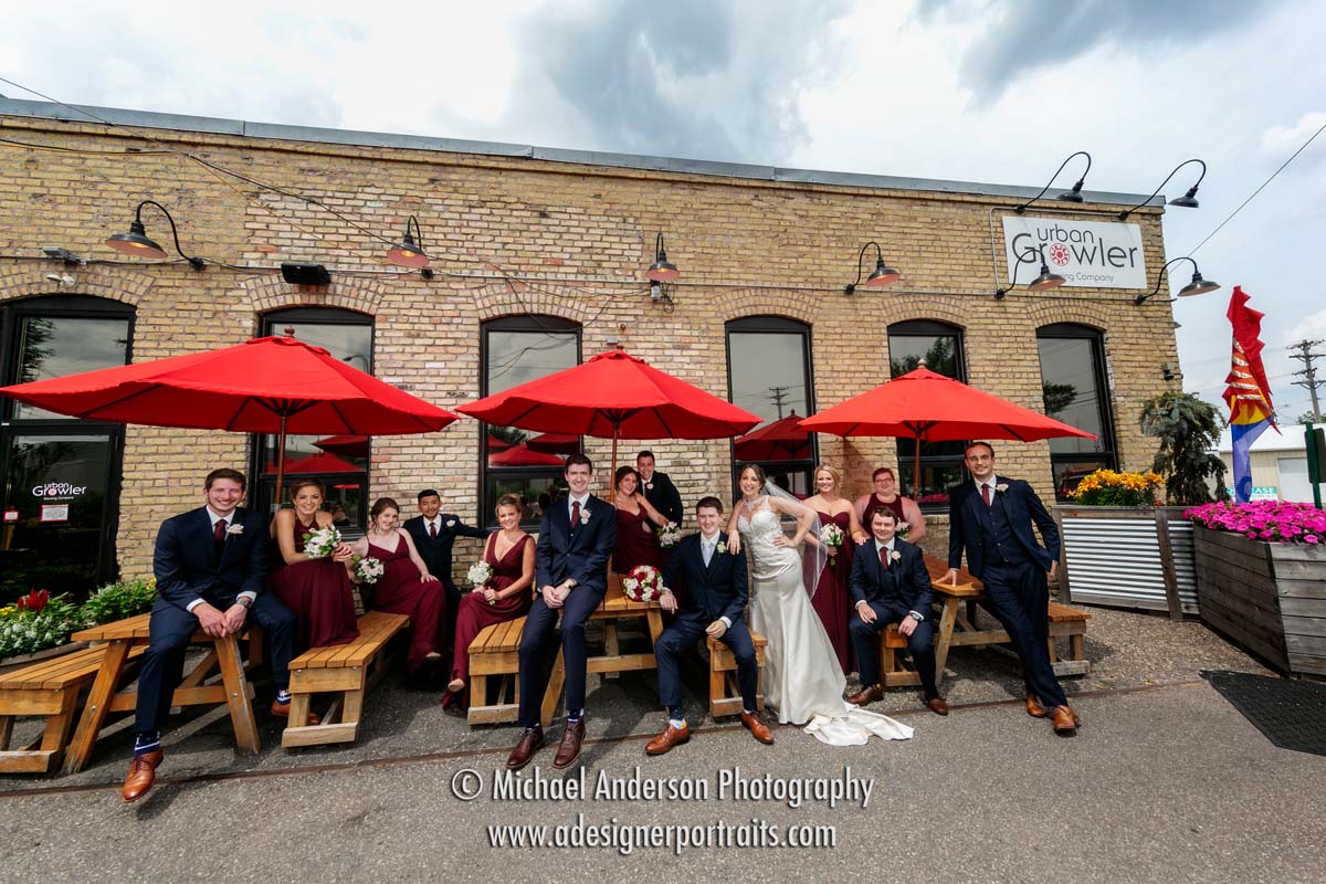 Ultra-wide angle Urban Growler Brewing Company wedding photo of a wedding party just outside the building.