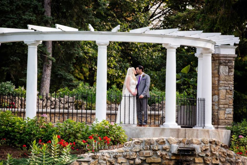 A pretty wedding photo of Chris and Sarah by the Frog Pond at Como Park in Saint Paul, MN.