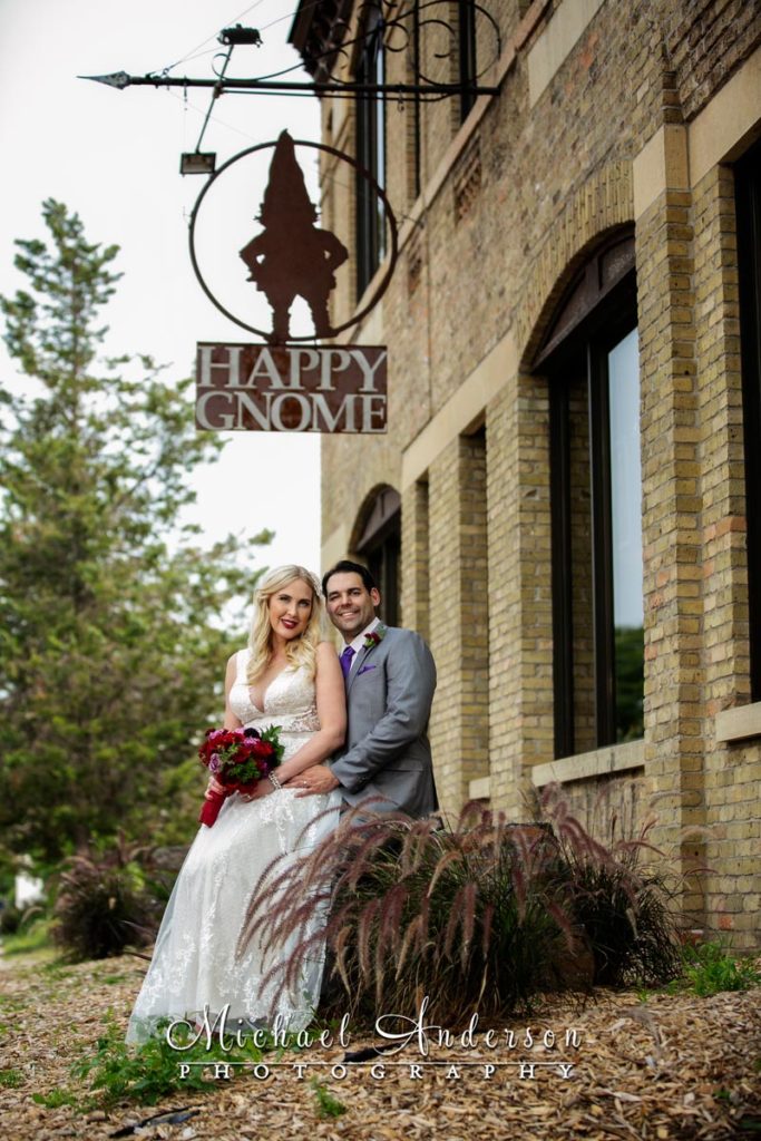 Wedding photograph of the bride and groom in front of the Happy Gnome in Saint Paul, MN.